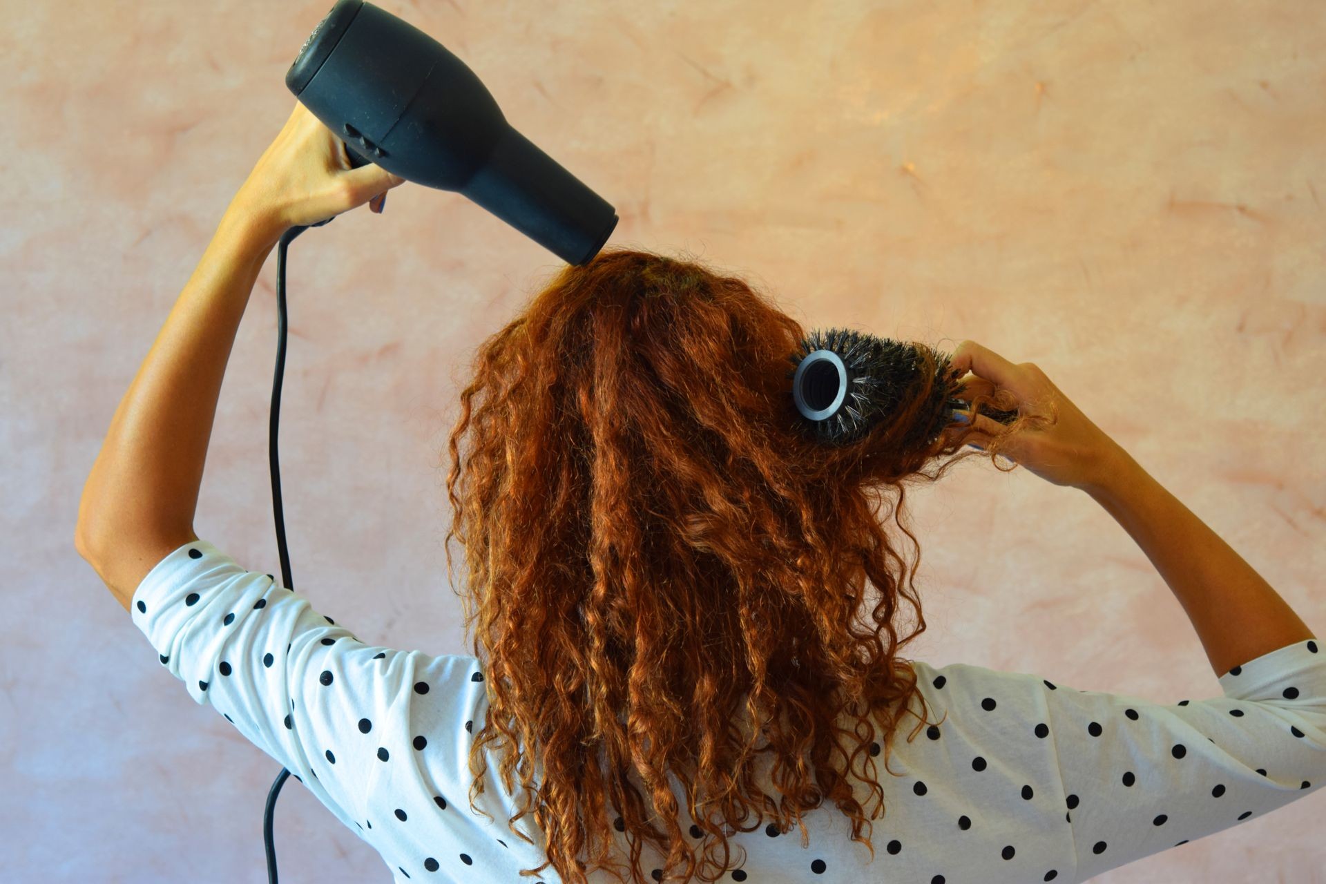 Curly hair girl drying her hair